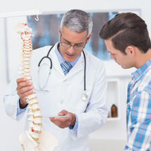 chiropractor pointing to spine
